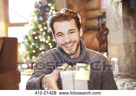 Man offering gifts on Christmas View Large Photo Image Stock Photo - Man offering gifts on Christmas. Fotosearch