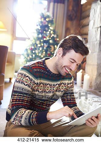 Man using digital tablet in log cabin View Large Photo Image Stock Photography - Man using digital tablet in log cabin. Fotosearch