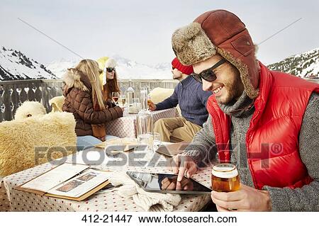 Man using digital tablet outdoors View Large Photo Image Stock Photo - Man using digital tablet outdoors. Fotosearch