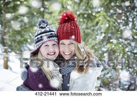 Mother and daughter hugging in snow View Large Photo Image Stock Image - Mother and daughter hugging in snow. Fotosearch