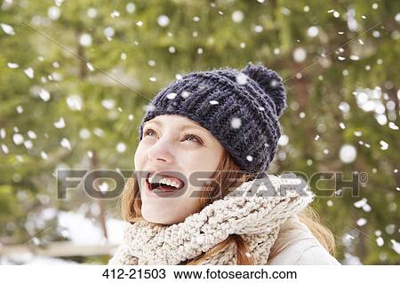 Woman admiring snow falling outside View Large Photo Image Stock Image - Woman admiring snow falling outside. Fotosearch