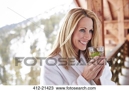 Woman having drink on cabin balcony View Large Photo Image Stock Image - Woman having drink on cabin balcony. Fotosearch