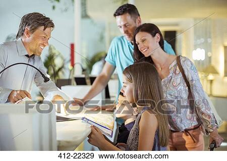 Family with two children at reception desk in hotel lobby View Large Photo Image Stock Photo - Family with two children at reception desk in hotel lobby. Fotosearch