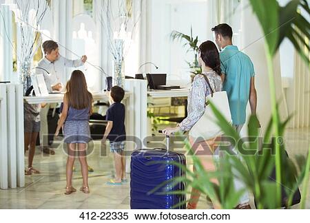 Family with two children at reception desk in hotel lobby View Large Photo Image Stock Photography - Family with two children at reception desk in hotel lobby. Fotosearch