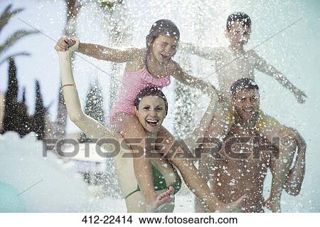 Family with two children enjoying themselves in swimming pool View Large Photo Image Picture - Family with two children enjoying themselves in swimming pool. Fotosearch