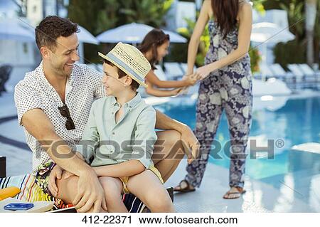 Family with two children enjoying themselves by swimming pool View Large Photo Image Stock Image - Family with two children enjoying themselves by swimming pool. Fotosearch