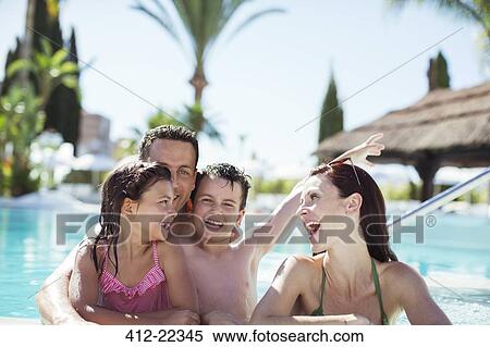 Family with two children enjoying themselves in swimming pool View Large Photo Image Stock Photography - Family with two children enjoying themselves in swimming pool. Fotosearch