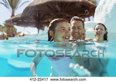 Family with two children in swimming pool on vacation View Large Photo Image Stock Photo - Family with two children in swimming pool on vacation. Fotosearch