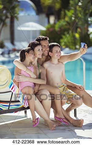 Family with two children taking selfie by swimming pool View Large Photo Image Stock Photo - Family with two children taking selfie by swimming pool. Fotosearch
