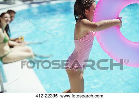Girl with pink inflatable ring jumping into swimming pool View Large Photo Image Stock Photography - Girl with pink inflatable ring jumping into swimming pool. Fotosearch