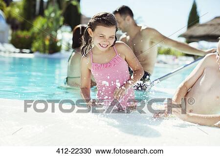 Happy children splashing water in swimming pool View Large Photo Image Stock Image - Happy children splashing water in swimming pool. Fotosearch