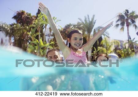 Stock Photo - Parents with daughter playing in swimming pool. Fotosearch