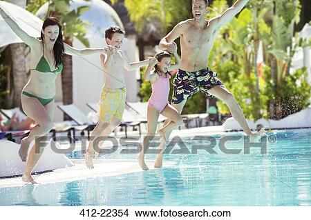 Picture - Parents with son and daughter holding hands, jumping into swimming pool. Fotosearch