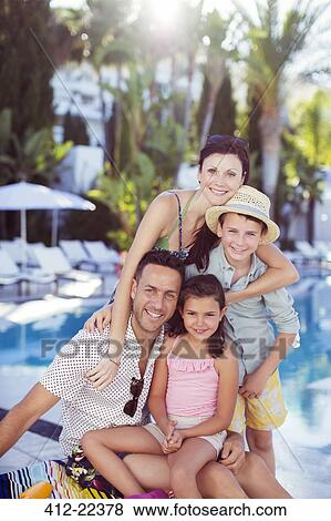Portrait of happy family by swimming pool View Large Photo Image Stock Photo - Portrait of happy family by swimming pool. Fotosearch
