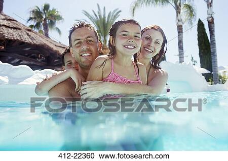 Portrait of happy family with son and daughter in swimming pool View Large Photo Image Stock Image - Portrait of happy family with son and daughter in swimming pool. Fotosearch