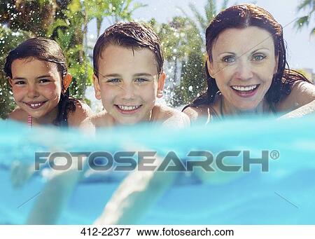Stock Photo - Portrait of mother with her two children in swimming pool. Fotosearch
