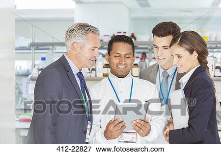 Scientist and business people using digital tablet in laboratory View Large Photo Image Stock Photo - Scientist and business people using digital tablet in laboratory. Fotosearch
