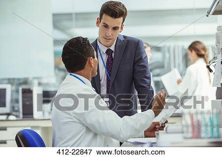 Scientist and businessman talking in laboratory View Large Photo Image Stock Photo - Scientist and businessman talking in laboratory. Fotosearch