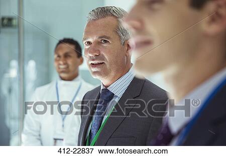 Stock Photo - Scientist and businessmen in laboratory. Fotosearch