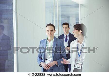 Scientist and businesswoman talking in hallway View Large Photo Image Stock Photo - Scientist and businesswoman talking in hallway. Fotosearch