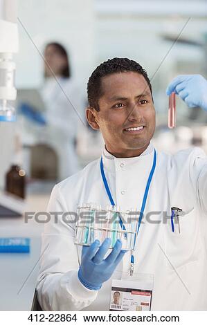 Scientist examining sample in test tube in laboratory View Large Photo Image Picture - Scientist examining sample in test tube in laboratory. Fotosearch