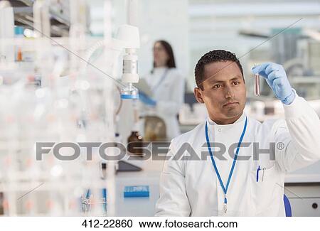 Scientist examining sample in test tube in laboratory View Large Photo Image Stock Image - Scientist examining sample in test tube in laboratory. Fotosearch