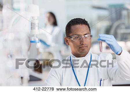 Scientist examining test tube in laboratory View Large Photo Image Stock Photo - Scientist examining test tube in laboratory. Fotosearch