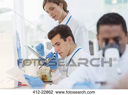 Scientist pipetting sample in laboratory View Large Photo Image Stock Image - Scientist pipetting sample in laboratory. Fotosearch