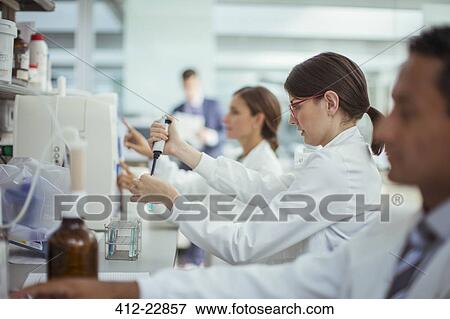 Scientist pipetting sample in laboratory View Large Photo Image Stock Photo - Scientist pipetting sample in laboratory. Fotosearch