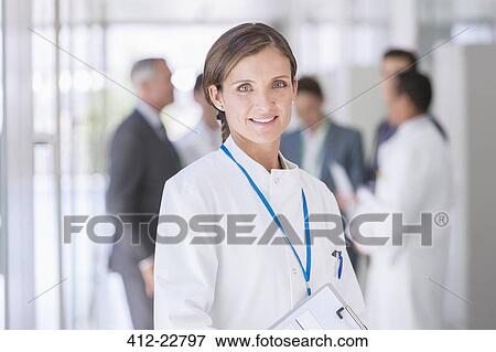 Stock Photo - Scientist smiling in hallway. Fotosearch