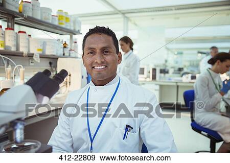 Scientist smiling in laboratory View Large Photo Image Stock Photo - Scientist smiling in laboratory. Fotosearch