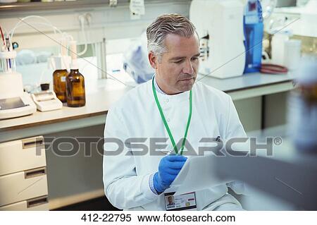 Scientist taking notes on experiment in laboratory View Large Photo Image Stock Photography - Scientist taking notes on experiment in laboratory. Fotosearch