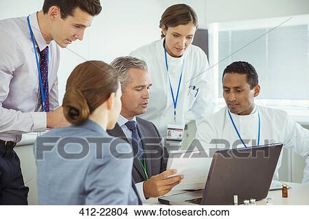 Scientists and business people talking in conference room View Large Photo Image Picture - Scientists and business people talking in conference room. Fotosearch