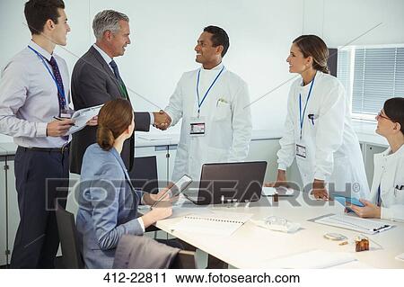 Scientists and business people talking in conference room View Large Photo Image Stock Image - Scientists and business people talking in conference room. Fotosearch