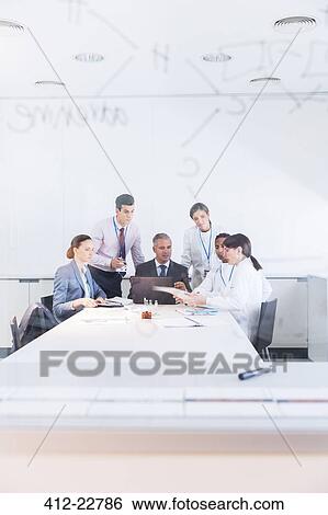 Scientists and business people talking in conference room View Large Photo Image Stock Photograph - Scientists and business people talking in conference room. Fotosearch