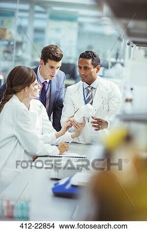 Scientists and businessman talking in laboratory View Large Photo Image Picture - Scientists and businessman talking in laboratory. Fotosearch