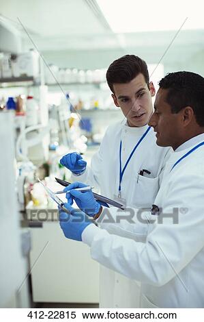 Stock Photography - Scientists taking notes in laboratory. Fotosearch