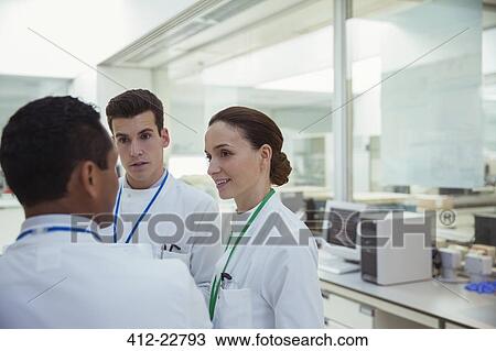 Stock Image - Scientists talking in laboratory. Fotosearch