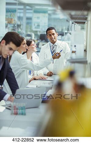 Stock Image - Scientists talking in laboratory. Fotosearch