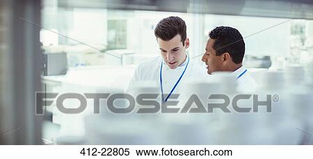 Stock Photography - Scientists talking in laboratory. Fotosearch