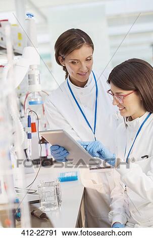 Scientists using digital tablet in laboratory View Large Photo Image Stock Image - Scientists using digital tablet in laboratory. Fotosearch