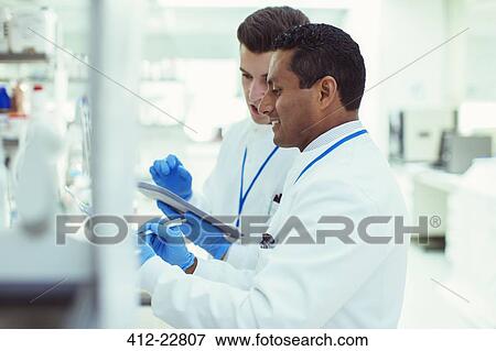 Scientists using digital tablet in laboratory View Large Photo Image Stock Photo - Scientists using digital tablet in laboratory. Fotosearch
