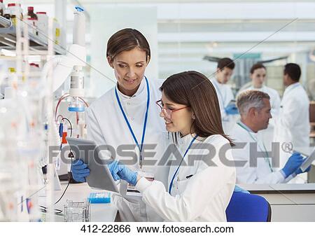 Scientists using digital tablet in laboratory View Large Photo Image Stock Photograph - Scientists using digital tablet in laboratory. Fotosearch