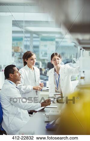 Stock Image - Scientists working in laboratory. Fotosearch