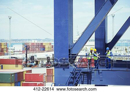 Business people and worker talking on cargo crane View Large Photo Image Picture - Business people and worker talking on cargo crane. Fotosearch