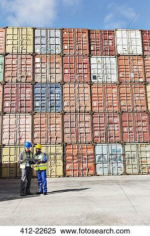 Businessman and worker talking near cargo containers View Large Photo Image Stock Photography - Businessman and worker talking near cargo containers. Fotosearch