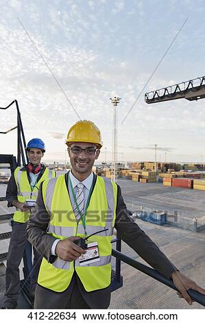 Picture - Businessman smiling on cargo crane. Fotosearch