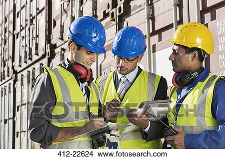 Businessmen and worker talking near cargo containers View Large Photo Image Picture - Businessmen and worker talking near cargo containers. Fotosearch