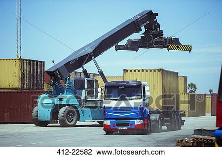 Crane near cargo container on truck View Large Photo Image Stock Image - Crane near cargo container on truck. Fotosearch