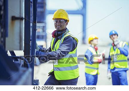 Worker climbing cargo crane View Large Photo Image Stock Photograph - Worker climbing cargo crane. Fotosearch